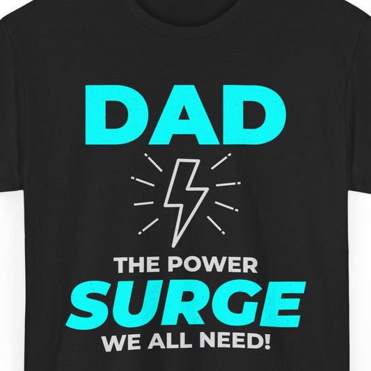 Black t-shirt with "DAD THE POWER SURGE WE ALL NEED!" and a lightning bolt graphic.