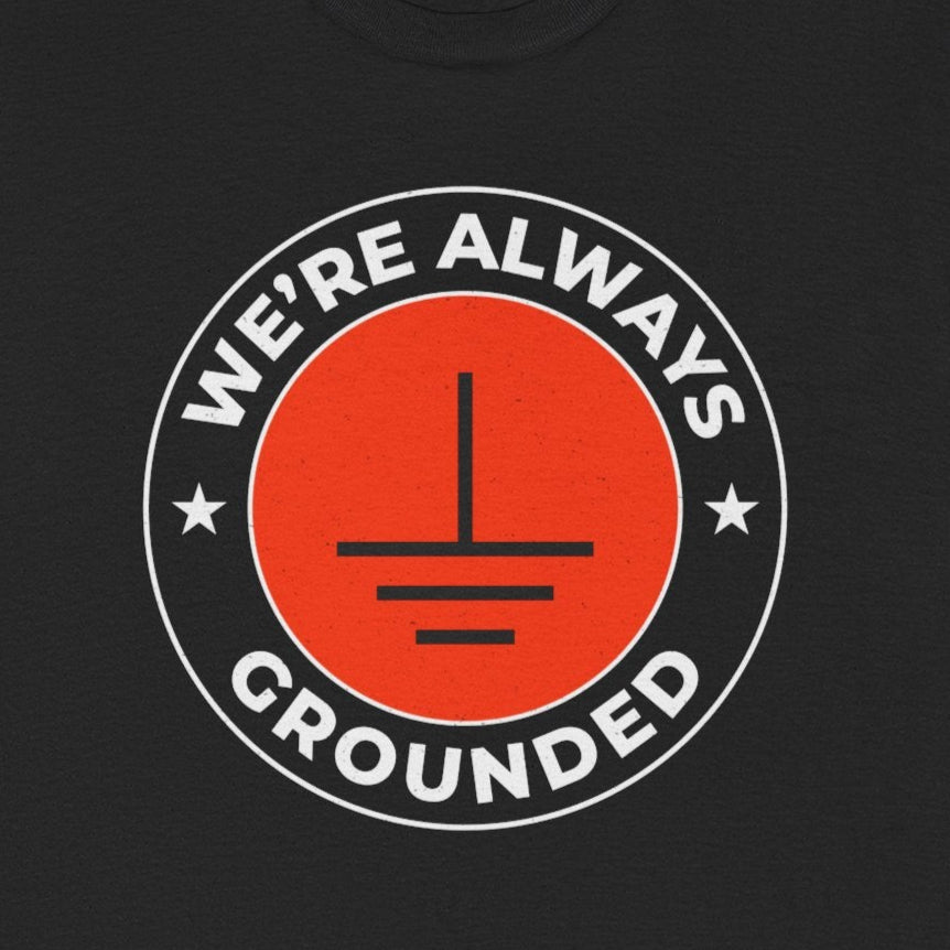 Electrician T-Shirt with "We're Always Grounded" text and a grounding symbol graphic.