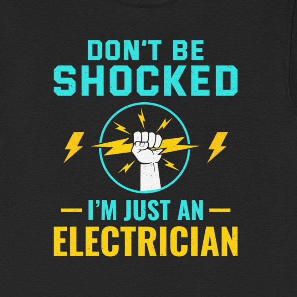 Electrician T-Shirt with "Don't Be Shocked, I'm Just An Electrician" text, a fist, and lightning bolt graphics.