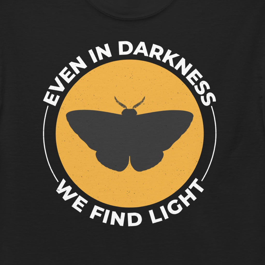 T-shirt with 'Even in Darkness, We Find Light' text