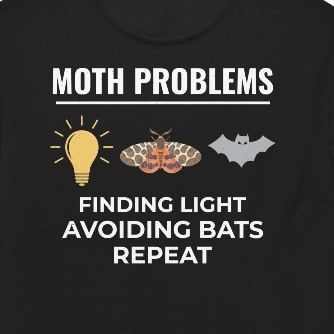 T-shirt with 'Moth Problems: Finding Light, Avoiding Bats, Repeat' text.